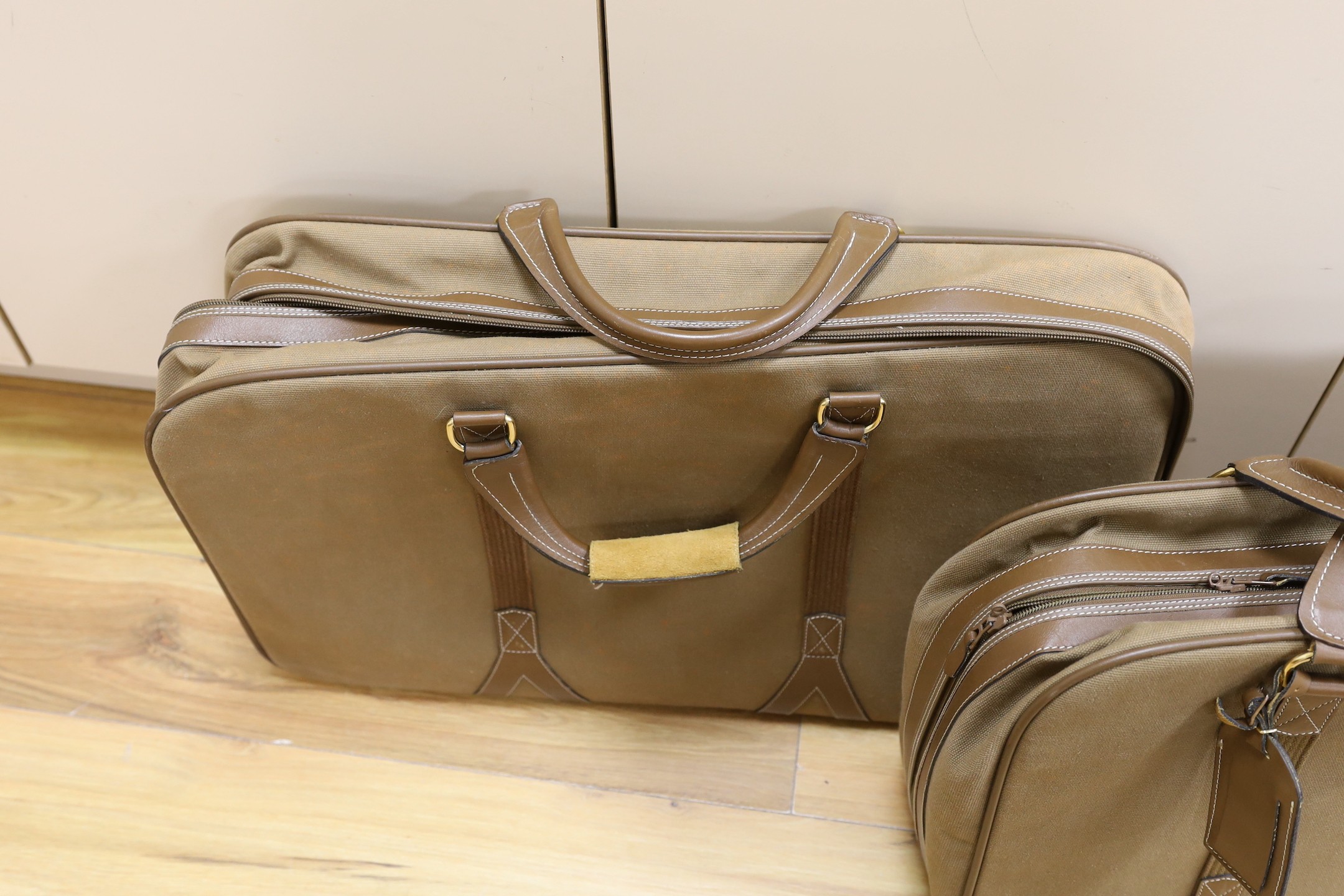 Two 1980's soft canvas Dunhill suit cases, largest 65 cms wide x 42 ms high.